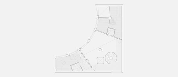 Architectural floor plan of the second floor, featuring curved walls, rooms, furniture, and a spiral staircase.