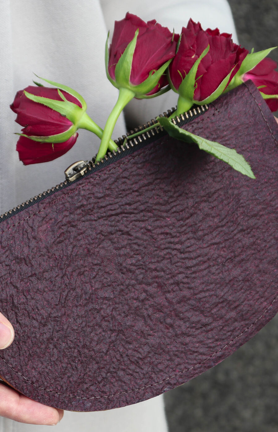 a close-up of a purple purse made out of flower waste