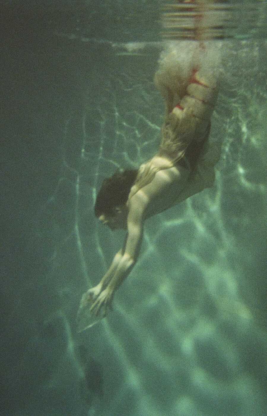 A person dives into water.
