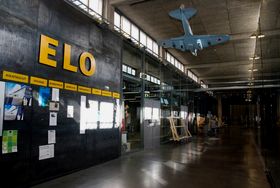 photo of corridor with a small plane hanging from the ceiling