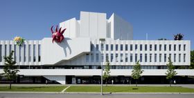 Image of the Finlandia building with three inflatable sculptures placed on its roof