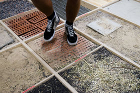 feet stepping on surfaces with sand, tile, gravel and hay to create different sounds