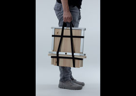 A portable kitchen being folded and carried