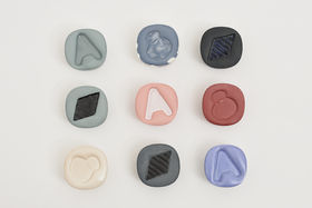 a set of small colourful ceramic containers