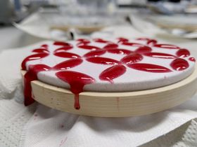 Sample with red colored recycled cellulose and ionic liquid solution after printing on fabric