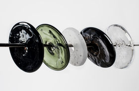 round shaped glass pieces that are penetrated by a metal stick