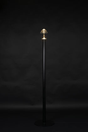 a glass sculpture / lamp with dark background