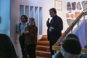Jason Selvarajan, Space 21 coordinator, Riikka Mäkikoskela, Head of Radical Creativity and Tuomas Auvinen, champion of Radical Creativity standing in the staircase giving speech in the event.