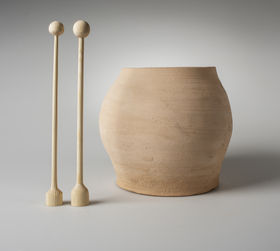 a ceramic pot with two wooden pedals