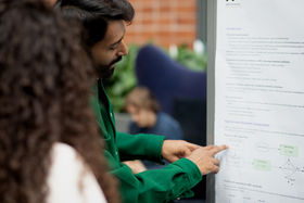 Scientist showing a poster