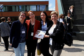 Erasmus+ Staff Training 2023 four participants standing outdoors and smiling. 