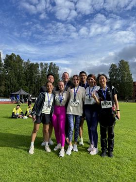 people on the grass with medals after run