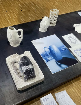 An exhibition layout presenting the mould, finished porcelain object and presentation  alongside initial sketchesposter