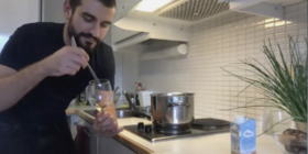 A dark haired man in a kitchen