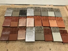 A collection of rectangular tiles with numbers and text, arranged in rows on a wooden surface.