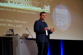 A man giving a presentation at Aalto University; text mentions Physics Days, MIT's Baker House, and the date Mar 4, 2026.