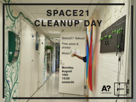 Poster in white hallway advertising Space21 Cleanup Day with free pizza, drinks and music, hand holding a cup.