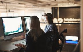 Two Aalto University students working at computers.
