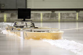 Model ship through ice in Aalto Ice Tank basin