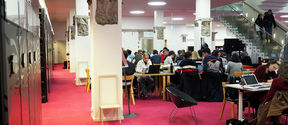 Photo from the K-floor of the Harald Herlin Learning Centre, students working at desks.