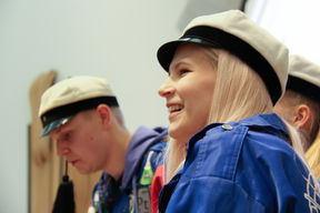 Anna smiling in her blue student overalls