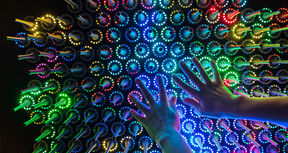 Hands touching an art piece on the quantum exhibition.