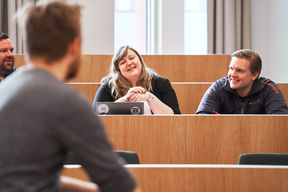 Students are chatting together in a classroom.