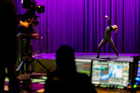 Dancer on stage wearing the Xsens motion capture suit