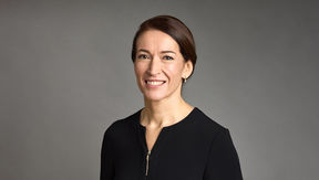 A portrait image of Suzanne Innes-Stubb, she smiles and gaze is towards the camera
