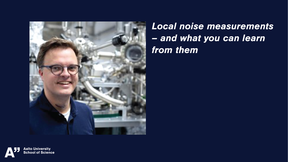 Photo of man with glasses standing in front of STM apparatus