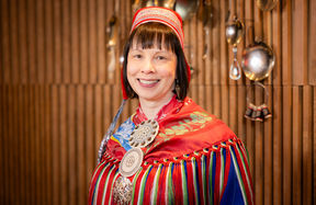 A portrait of a brown-haired woman wearing traditional samí costume.