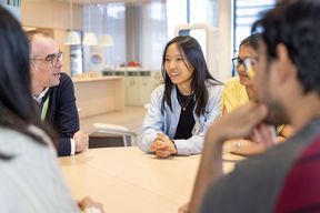 People sitting around a table talking.