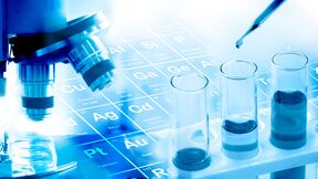 Laboratory scene with microscope, periodic table, test tubes and dropper.