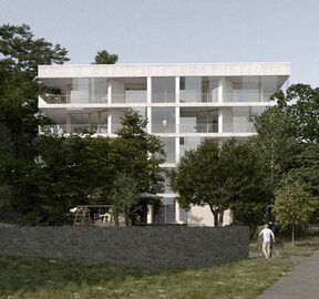 Modern white apartment building with large balconies, surrounded by trees. An elderly person walks with a bicycle.