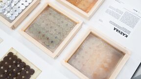 Four wooden-framed samples with various textures and colours on a white surface, next to a paper labelled 'KASVAA'.