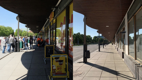 Split image of a busy shop entrance on the left and an empty sidewalk with closed shops on the right.
