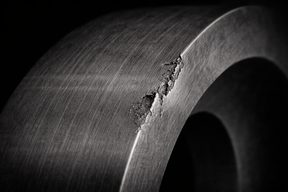 Mechanical defect in the ring of the ball bearing.