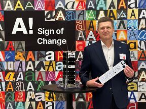 President Ilkka Niemelä holds an Aalto satellite panel signed by donors.