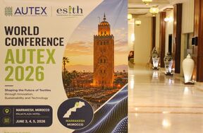 AUTEX 2026 world conference poster with Marrakesh tower image in a bright hotel lobby