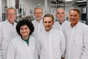 The SisuSemi team in lab coats, smiling at the camera. 6 people, 5 men and 1 woman