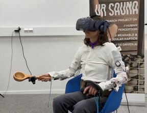 Image shows a person wearing a thermal interface that produces dynamic heat in a VR experience