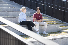 two students sitting outside