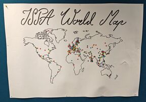 White poster reading “ISPA World Map” with an outlined world map covered in small coloured stickers