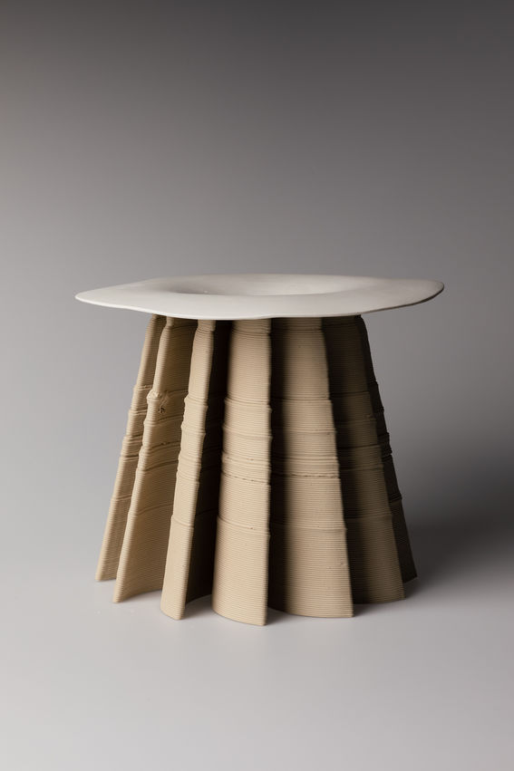 3d printed ceramic stool looking object with slip cast top