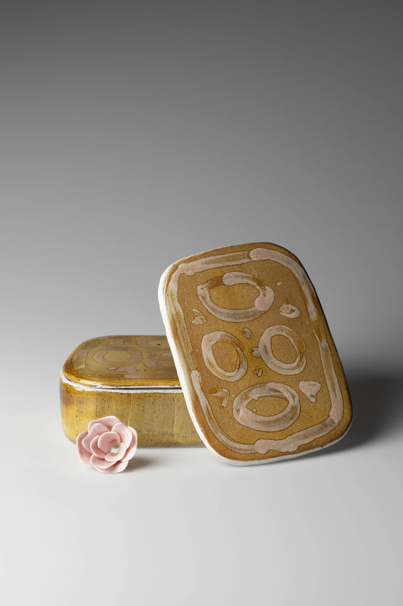 a ceramic box with painting on the lid