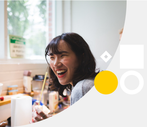 a laughing woman in an art workshop