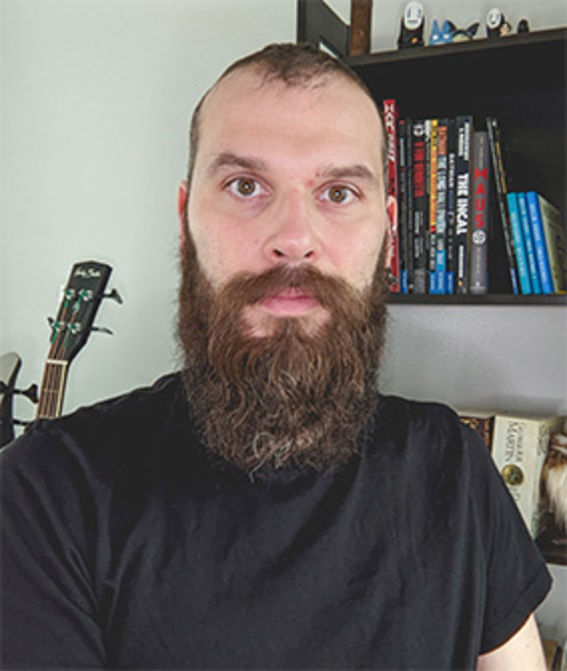 portrait showing a male face in front of a book shelf