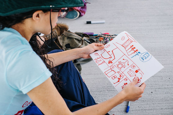 Girl looking at a drawing regarding sanitation practices