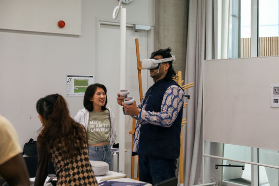 student observing another student trying a VR experience