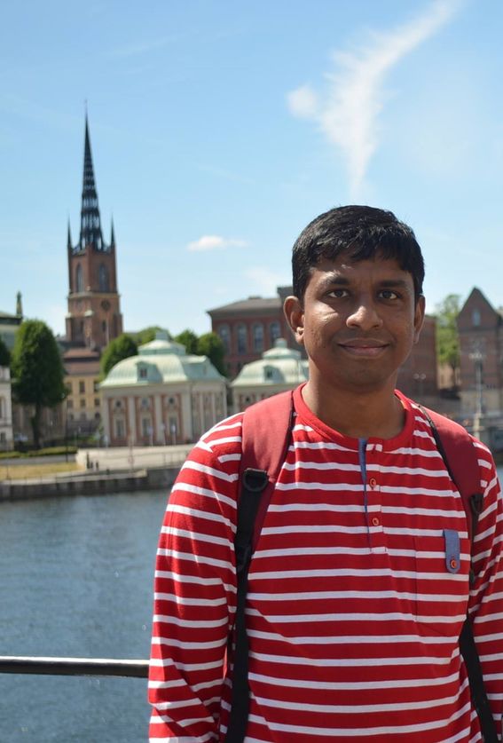 Photo of man standing in front of a rive promenade